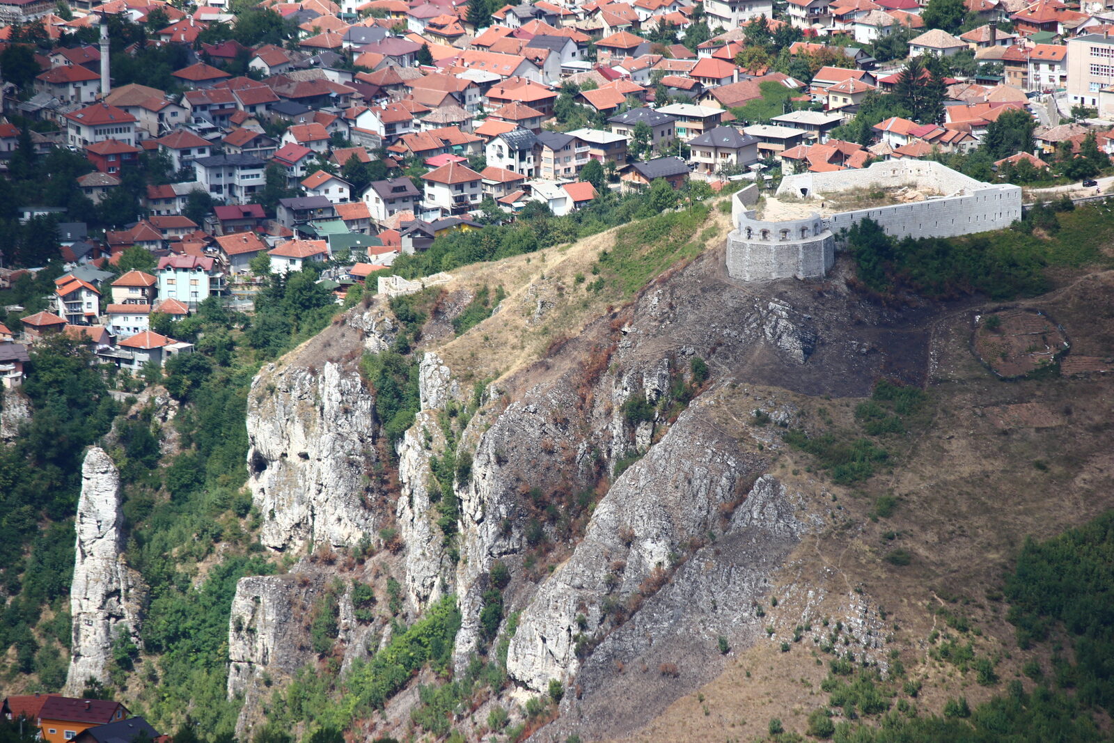The ruins of Bijela Tabija (White Fortress) above Vratnik on the hillside above Sarajevo, with the city in the valley below.