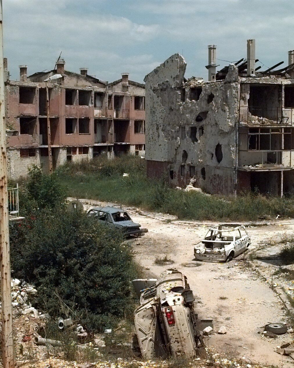 Rows of pockmarked and shell-damaged apartment blocks in the Dobrinja neighbourhood of Sarajevo, photographed in June 1996 shortly after the end of the siege.