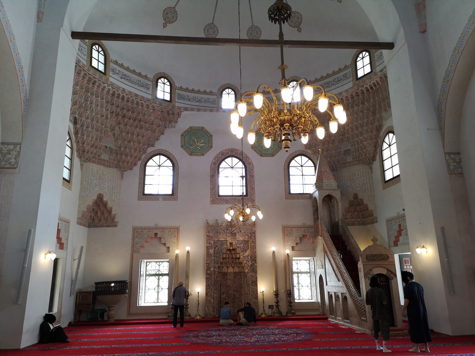 The interior of Gazi Husrev-beg's Mosque, looking up at the painted ceiling beneath the central dome.