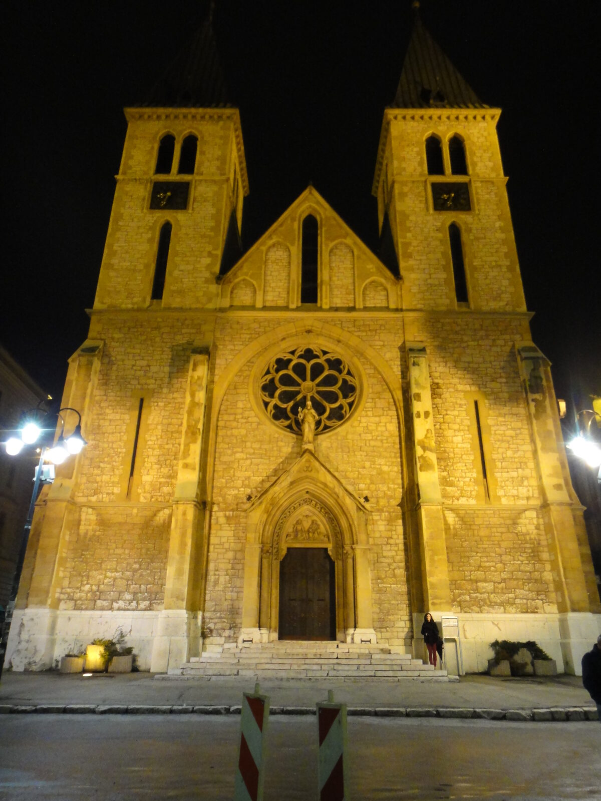 The illuminated façade of Sacred Heart Cathedral at night.