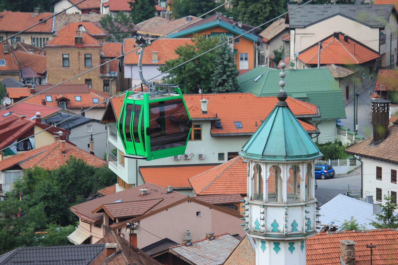 A Sarajevo cable car gondola passing a minaret on the Bistrik side of the line.