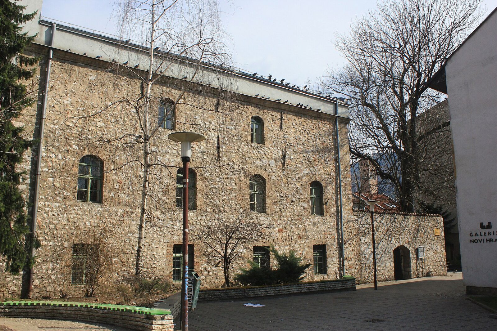 The Old Sephardic Synagogue in Sarajevo — a plain rectangular stone building dating from 1581, part of the Great Courtyard (Il Cortijo) quarter established by the Sephardic Jews who arrived in the city after the 1492 Alhambra Decree. Today houses the Museum of Jews of Bosnia and Herzegovina.