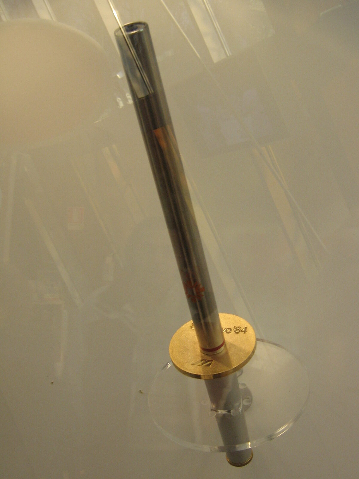 The 1984 Winter Olympics torch monument in Sarajevo, a tall metallic flame sculpture on a stone pedestal, photographed in the city centre.