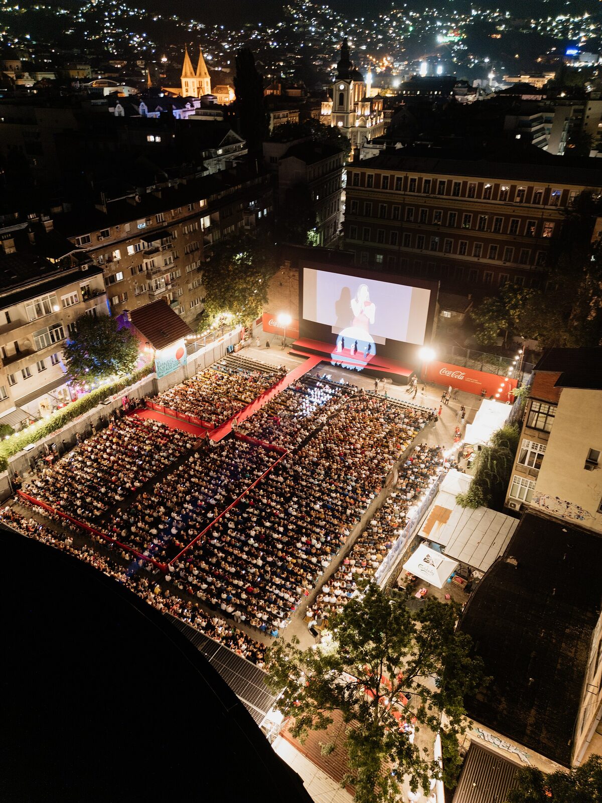Aerial view of the Sarajevo Film Festival open-air cinema at night, a packed audience in central Sarajevo.