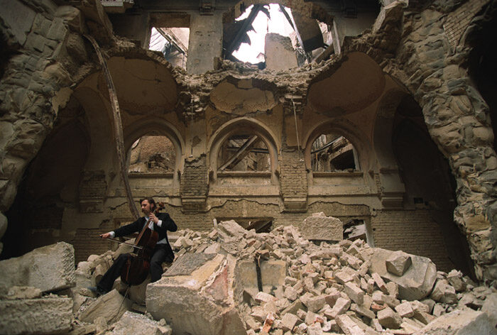 Vedran Smailović plays his cello in the ruined National Library during the siege of Sarajevo, 1992.