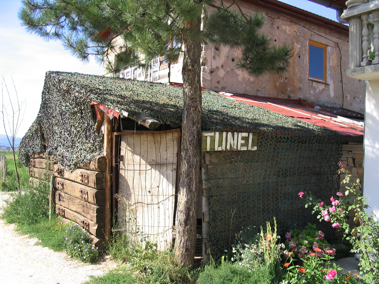 The tunnel mouth itself — a low concrete arch under the Sarajevo airport runway.